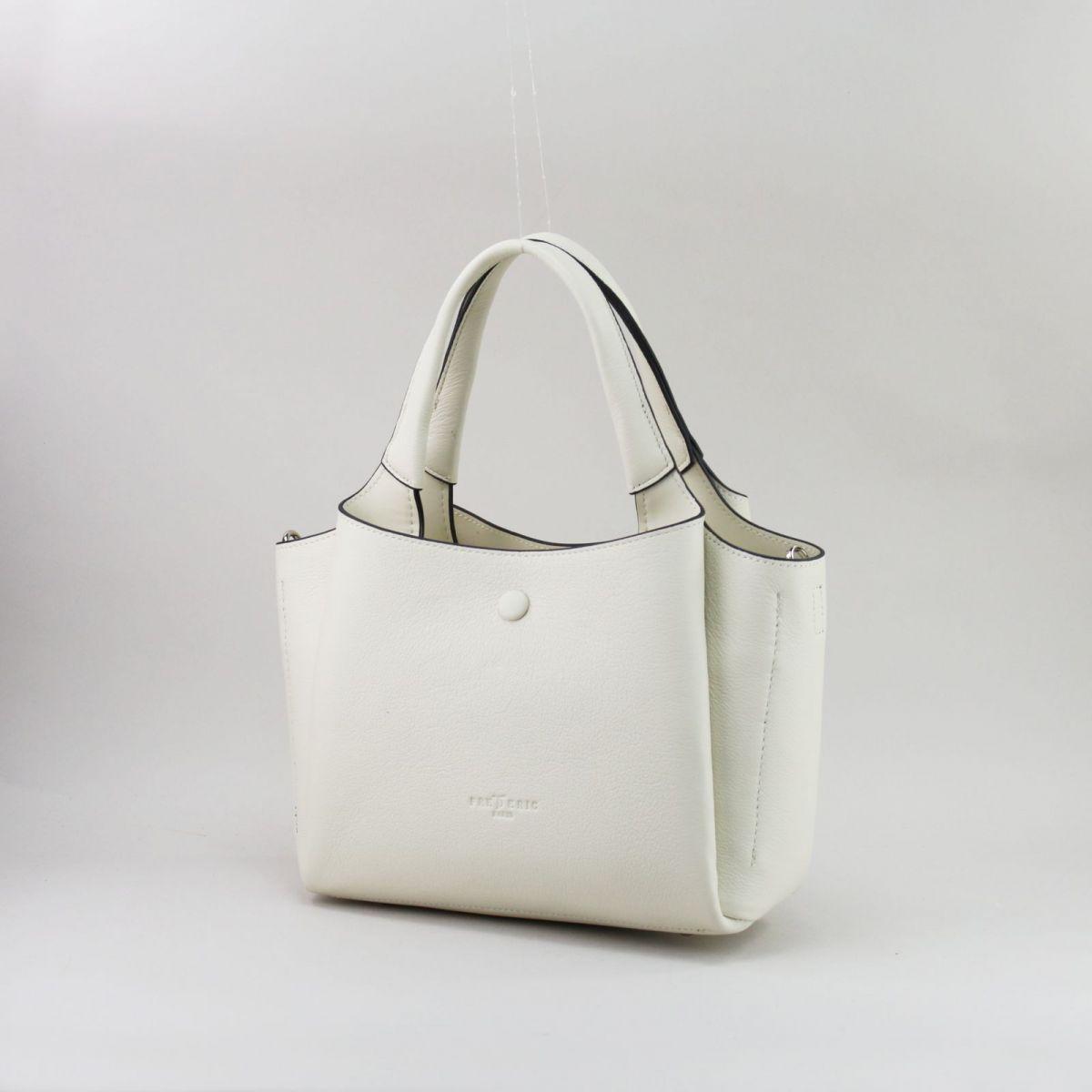 Creamy white genuine leather handbag with silver hardware, featuring three separate compartments (middle with zip closure), two inner pockets including one zippered, and a rear external zip pocket. Comes with short top handles and a detachable adjustable strap for shoulder or crossbody wear. | Šiltai balta natūralios odos rankinė su sidabrine furnitūra, 3 skyriais ir universaliu dizainu – elegancija kasdienai.