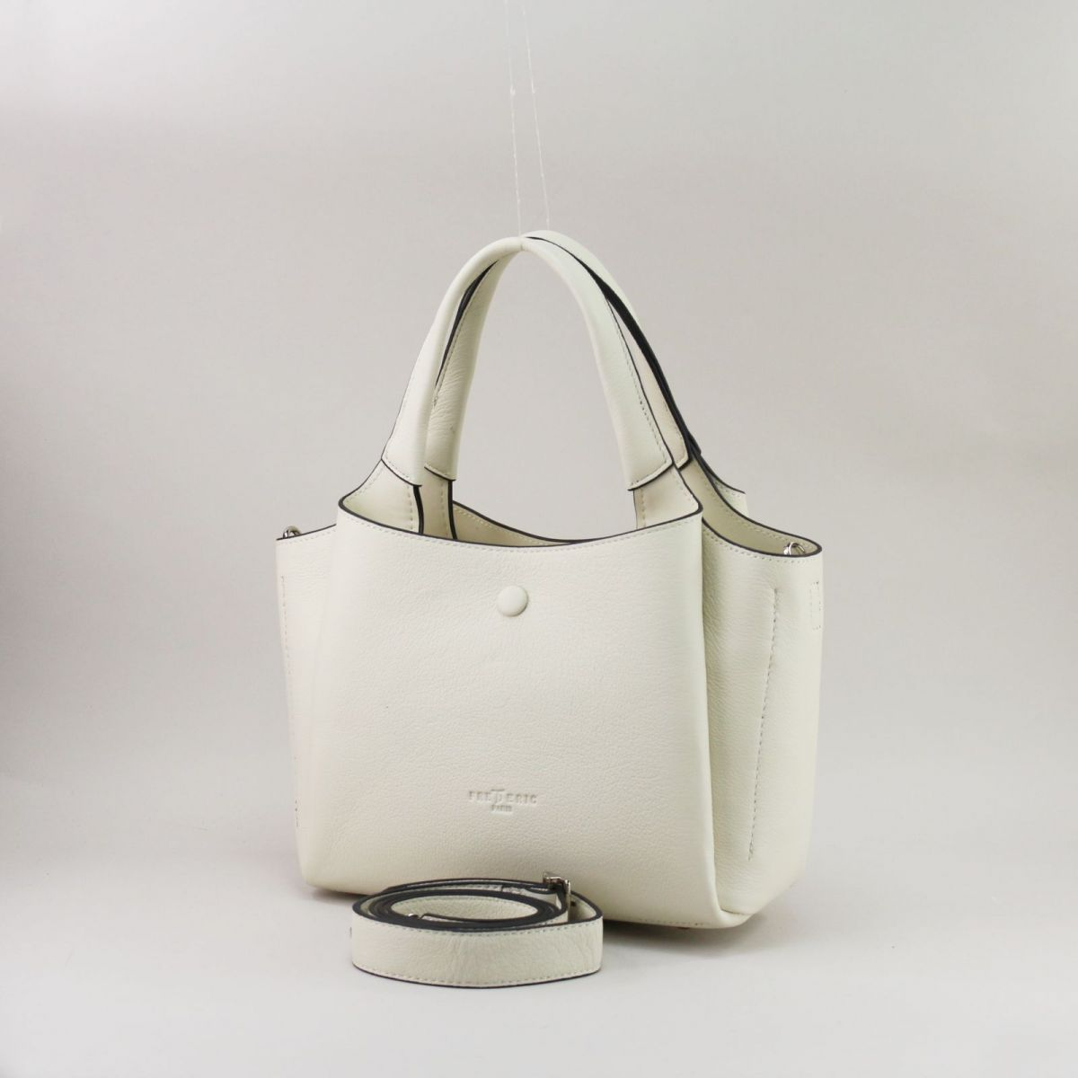 Creamy white genuine leather handbag with silver hardware, featuring three separate compartments (middle with zip closure), two inner pockets including one zippered, and a rear external zip pocket. Comes with short top handles and a detachable adjustable strap for shoulder or crossbody wear. | Šiltai balta natūralios odos rankinė su sidabrine furnitūra, 3 skyriais ir universaliu dizainu – elegancija kasdienai.