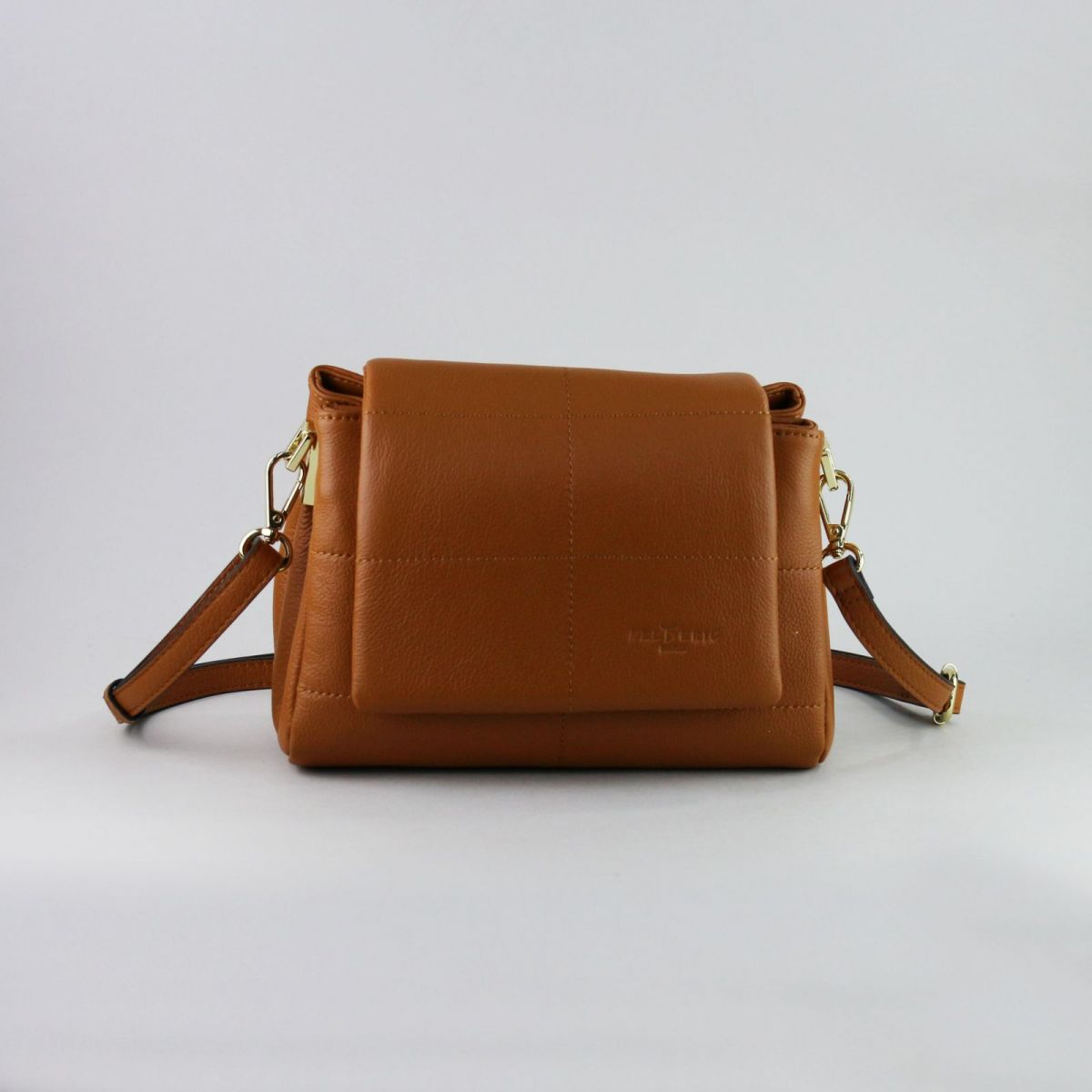 Caramel brown genuine leather handbag with flap closure, gold-tone hardware, adjustable shoulder strap (up to 115 cm), and exterior back zip pocket. Created by a trusted French manufacturer, this compact design is both elegant and practical – perfect for everyday or evening wear. | Karamelinės rudos spalvos natūralios odos rankinė su auksine furnitūra ir atvartu – stilingas ir mėgstamas modelis kasdienai ar išėjimui.

