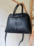 Elegant black genuine leather handbag with structured silhouette, silver-tone hardware, two sturdy top handles and a detachable adjustable shoulder strap (max 115 cm). Features a zippered main closure, spacious interior compartment, and an exterior back pocket with zipper. High-quality natural leather, durable shape, suitable for carrying on the shoulder or crossbody. Dimensions: 36 × 26 × 12.5 cm, weight 1 kg. / Elegantiška juoda natūralios odos rankinė su tvirtu siluetu, sidabrinėmis detalėmis, dviem rank