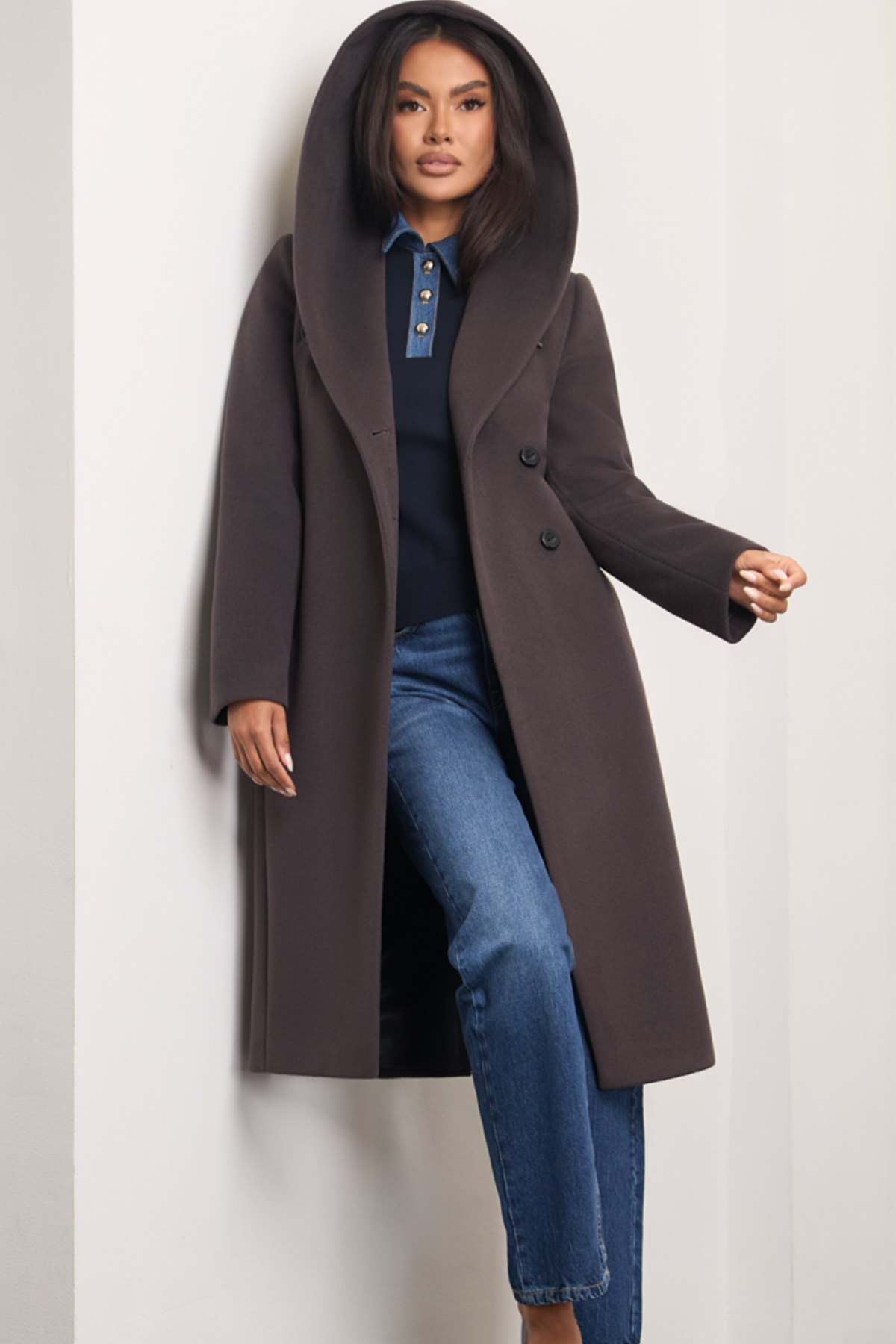Brown espresso wool coat Zoe for women – long elegant winter coat with soft hood, belt at the waist, side pockets and back vent. Insulated and lined, warm and chic. Model is wearing size 34. Rudas vilnonis paltas Zoe – ilgas, šiltas paltas su kapišonu, diržu ir klasikinėmis detalėmis.