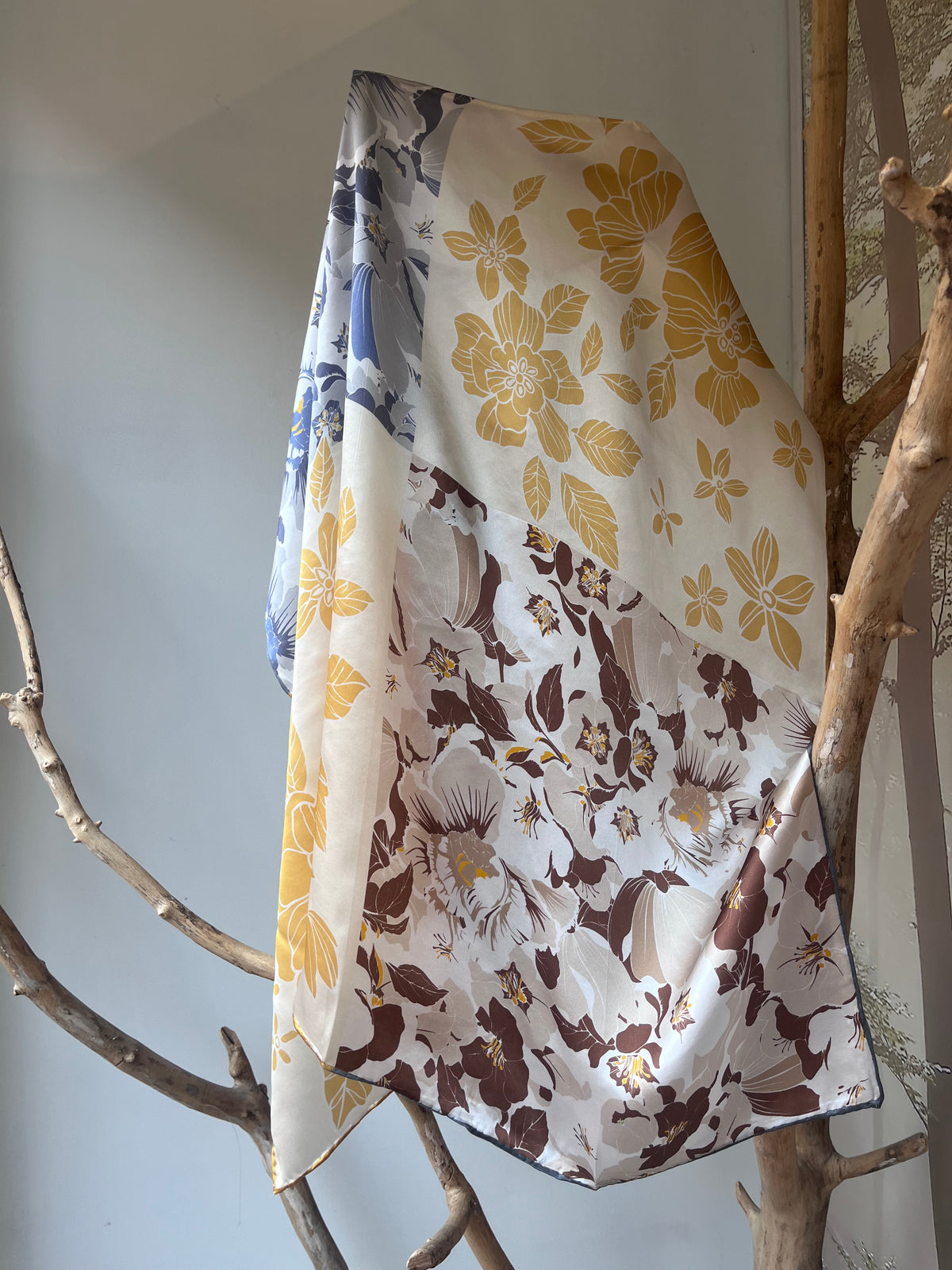 Silk scarf for women 90x90 cm with multicolor floral design in yellow, blue and brown tones, versatile accessory that looks different when tied from each corner, luxury silk square scarf for neck, hair or handbag, elegant gift idea, Šilkinė skarelė moterims 90x90 cm su daugiaspalviu gėlių motyvu geltonuose, mėlynuose ir ruduose atspalviuose, universalus aksesuaras, kuris atrodo skirtingai užrištas iš kiekvieno kampo, prabangi šilko kvadratinė skarelė kaklui, plaukams ar rankinei, elegantiška dovanos idėja.