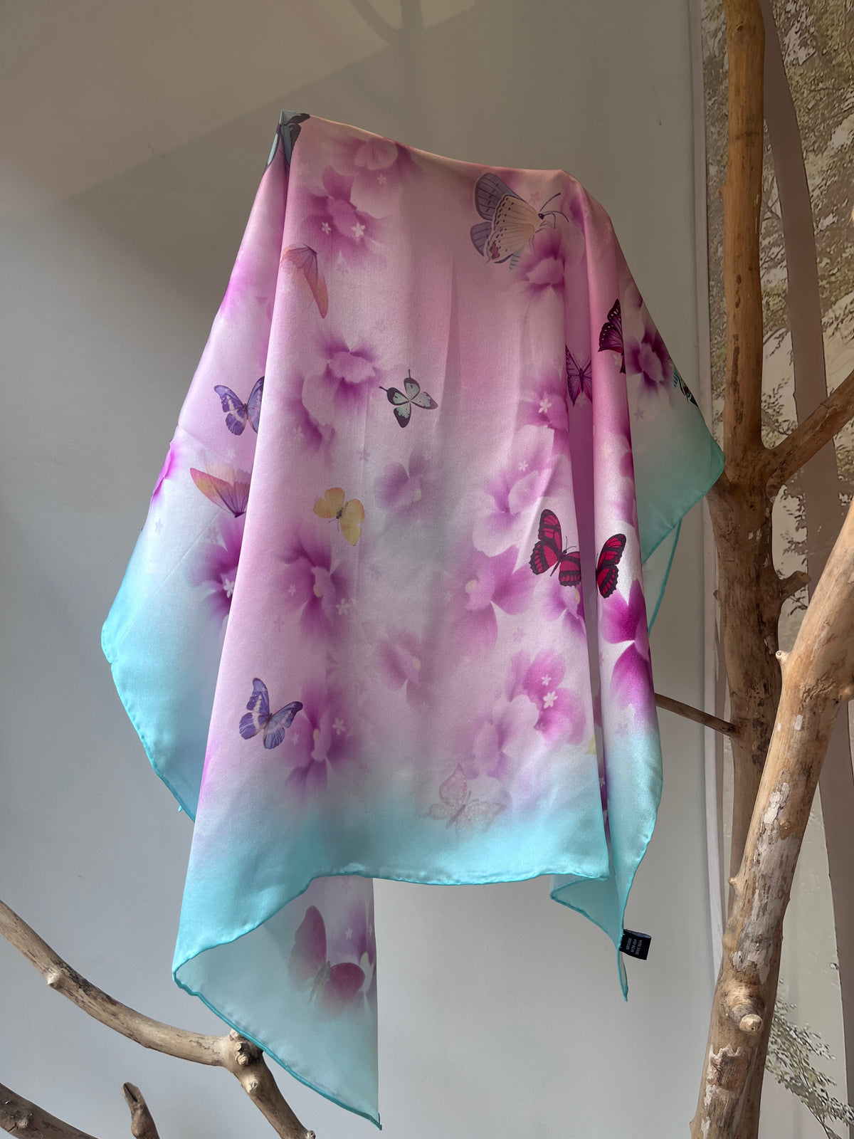 Turquoise silk scarf for women 90x90 cm with butterfly and floral print, luxury square silk scarf in pastel turquoise and pink, romantic and elegant accessory for neck, hair or handbag, perfect spring gift, Turkio šilkinė skarelė moterims 90x90 cm su drugelių ir gėlių motyvu, prabangi kvadrato formos šilko skarelė pastelinių turkio ir rožinių spalvų, romantiškas ir elegantiškas aksesuaras kaklui, plaukams ar rankinei, subtili dovana pavasariui.